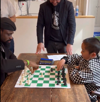Nigerian Chess In The Slum Convener Onakoya Plays With 8-Year-Old Chess Prodigy