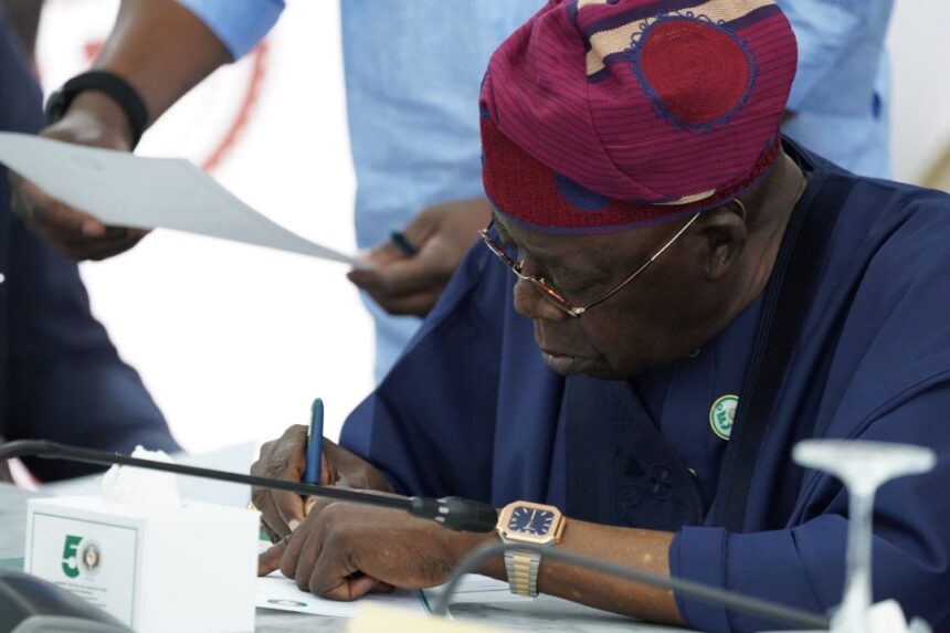 Photos: President Bola Tinubu Signs The ECOWAS 50th Anniversary Card