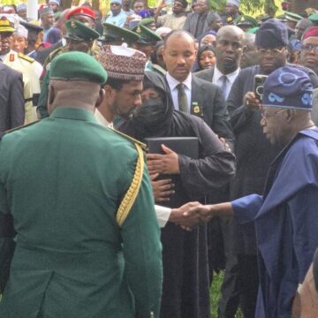 Aisha Buhari Hugging The Nigerian Flag That Draped The Remains Of General Buhari After It Was Handed Over To Her By President Bola Tinubu.