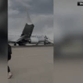 Passengers Flee Smoking Jet On Emergency Slide After Apparent Landing Gear Problem At Denver Airport