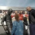 Thierry Henry Children View His Stature At The South-East Corner Of Emirates Stadium, Depicting His Famous Goal Celebration Against Tottenham Hotspur