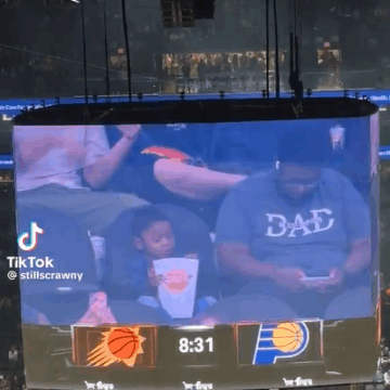 image Something To Brighten Your Monday With: Toddler With A Popcorn Bucket Bigger Than Him, Waves Charmingly At Suns-Hawks Game, Gives Wholesome Reaction Online