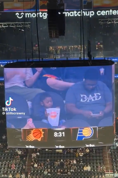 image Something To Brighten Your Monday With: Toddler With A Popcorn Bucket Bigger Than Him, Waves Charmingly At Suns-Hawks Game, Gives Wholesome Reaction Online