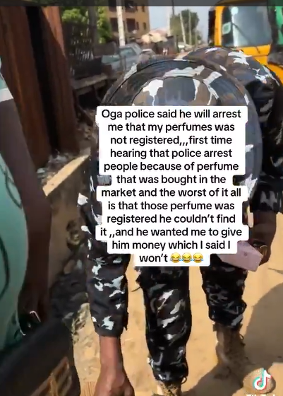 Video Footage Shows Nigerian Police Officer Confront Perfume Vendor Over NAFDAC Registration He Fails To Find On The Bottle