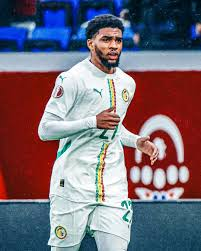 image 17-Year-Old Ibrahim Mbaye Pointing His Hands To The Two Star Badge Recently Won By Lifting AFCON 2025